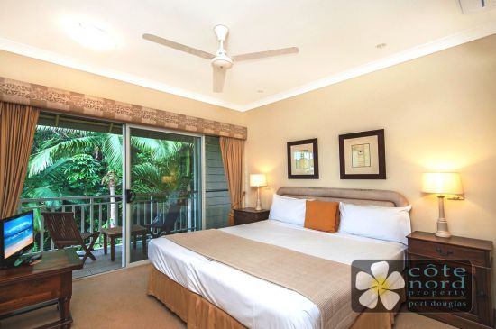 Spacious upstairs main bedroom with balcony