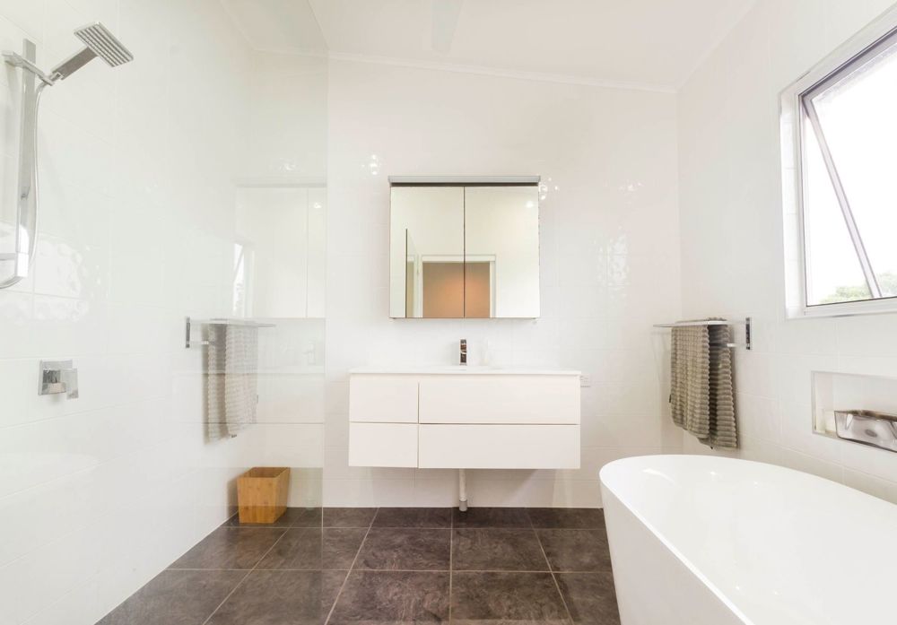 Bathroom with bath and double showers