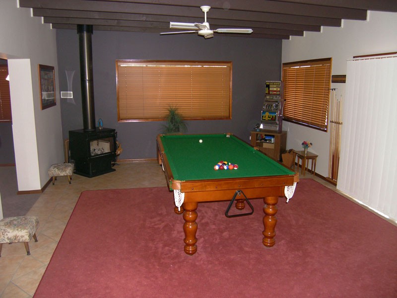 Games room with cosy wood heater