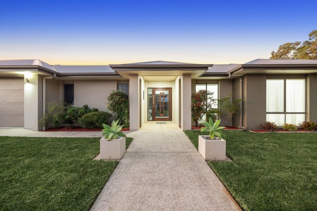 Executive 4 bedroom home with air conditioning, inground pool and multiple living areas.